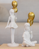 Escultura em Resina Branca Menina com balão dourado 27cm x 10cm